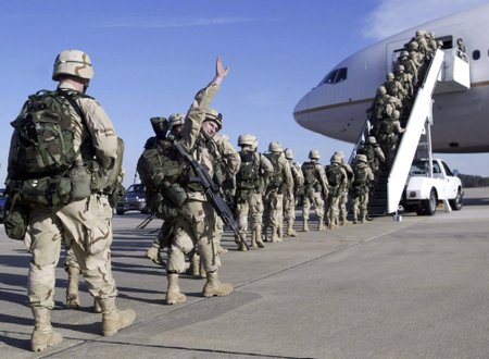File photo of a U.S. Army paratrooper from the 82nd Airborne waving good-bye before a deployment to Kuwait