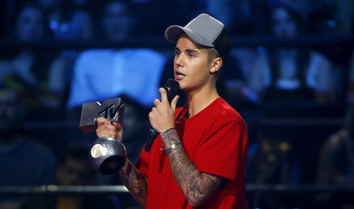 Canadian singer Bieber holds the "Best Collaboration" award during the MTV EMA awards at the Assago forum in Milan