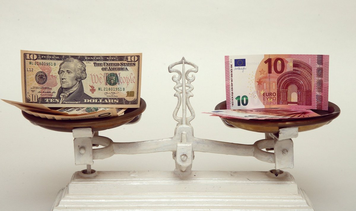 A picture illustration shows U.S. Dollar and Euro banknotes on a pair of scales in Vienna