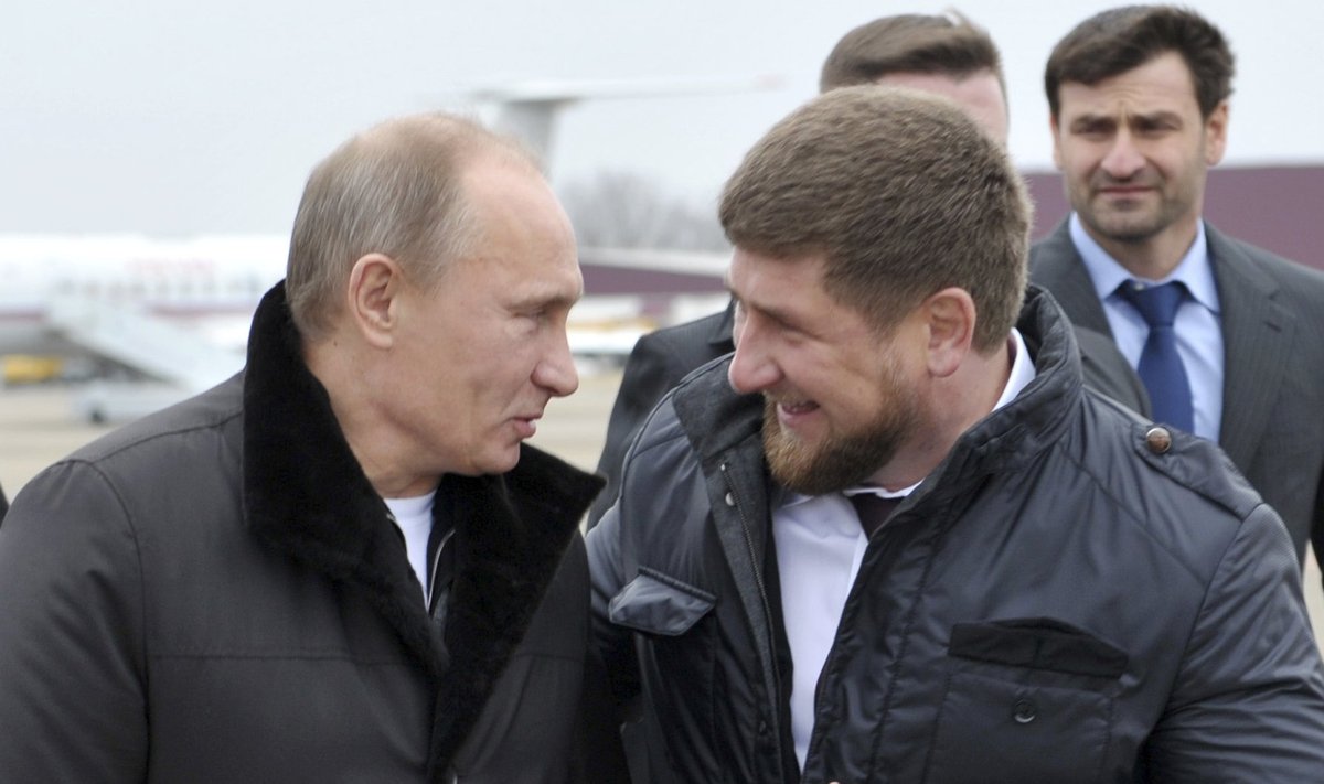 Russian PM Putin talks with Chechen leader Kadyrov after arriving in the Chechen town of Gudermes