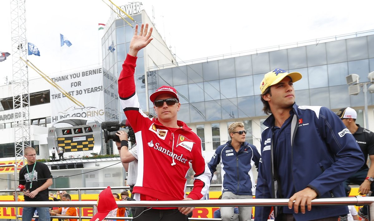 Ferrari Formula One driver Raikkonen of Finland waves next to Sauber Formula One driver Nasr of Brazil during the drivers parade before the Hungarian F1 Grand Prix at the Hungaroring circuit, near Budapest
