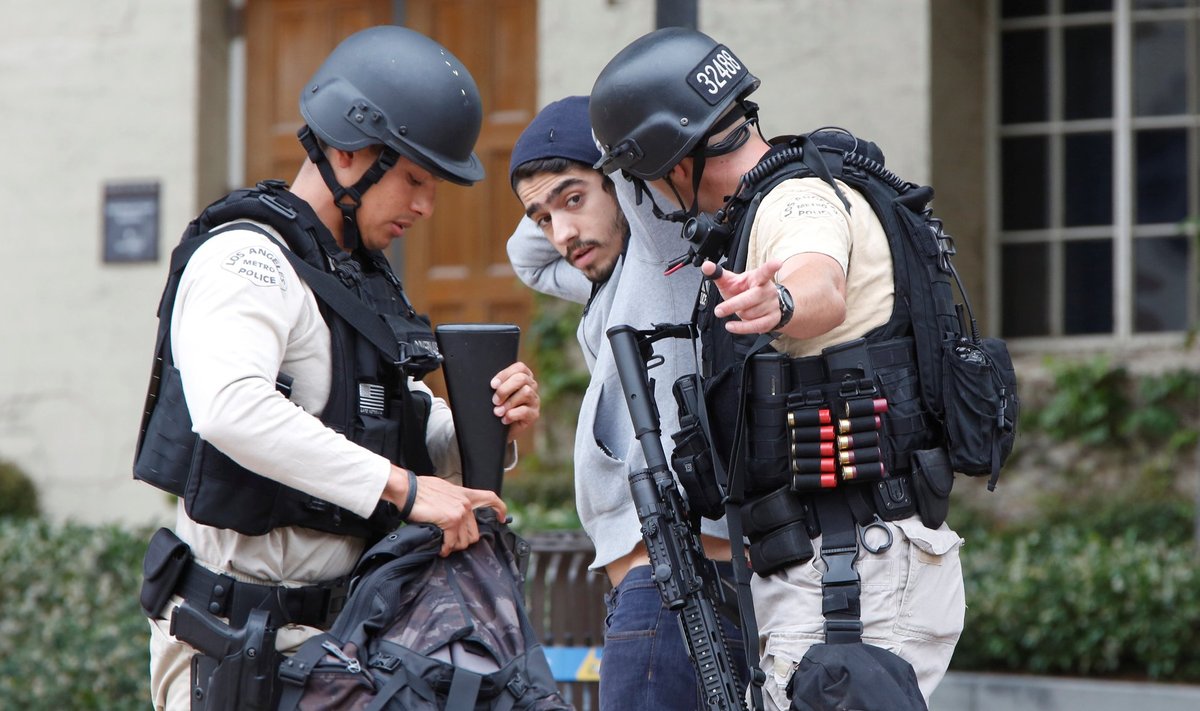 Police officers search a student's belongings at the University of California, Los Angeles (UCLA) campus after it was placed on lockdown following reports of a shooter in Los Angeles