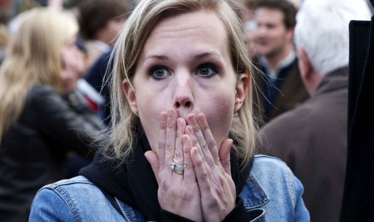 A person attending the Remembrance Day reacts on the Dam in Amsterdam, on May 4, 2010. After a minute silence there was a rumour and people ran away yelling. Several man, also children, were carried away. Queen Beatrix and her supporting team left the remembrance and came back after a short time. AFP PHOTO/ NP ROYAL IMAGES ROBIN UTRECHT/ netherlands out - belgium out