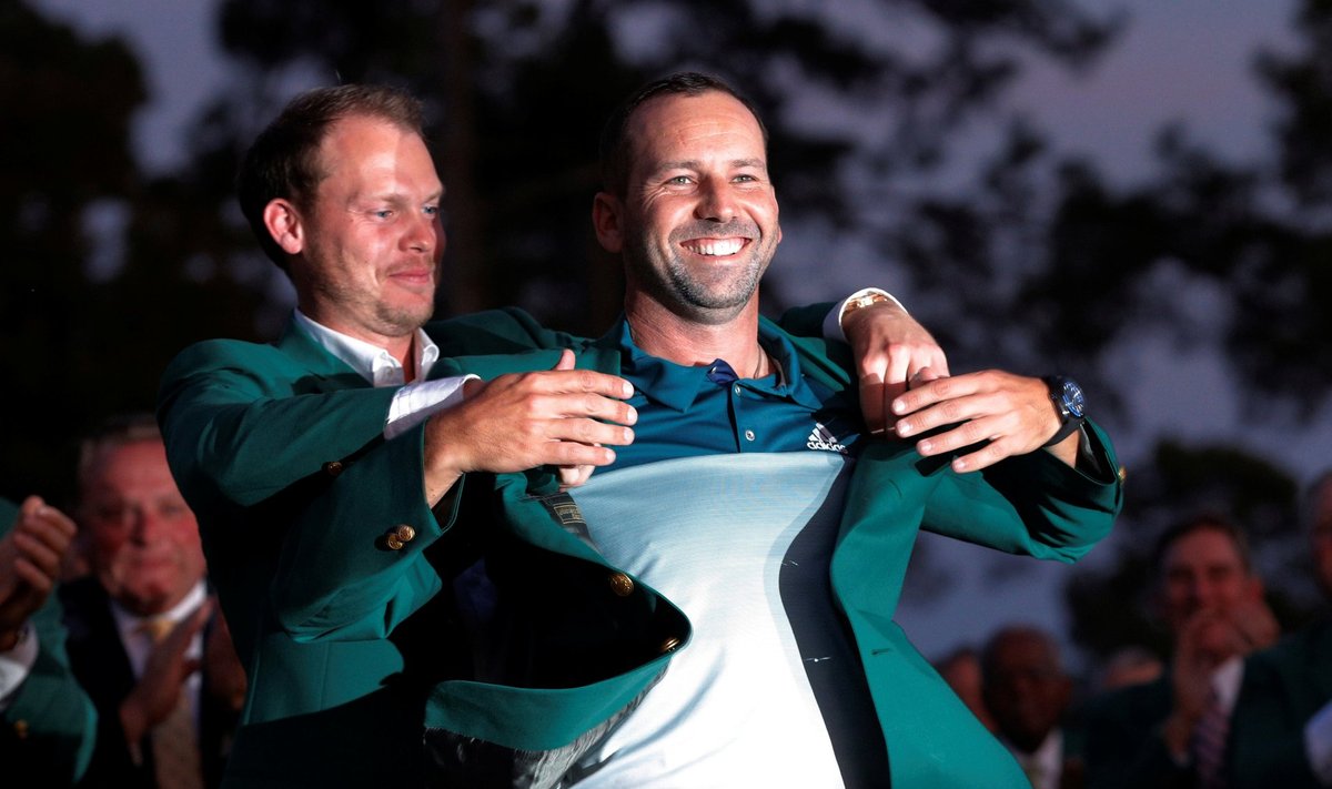 Garcia of Spain is presented the green jacket by Willett of England after Garcia won the 2017 Masters in Augusta
