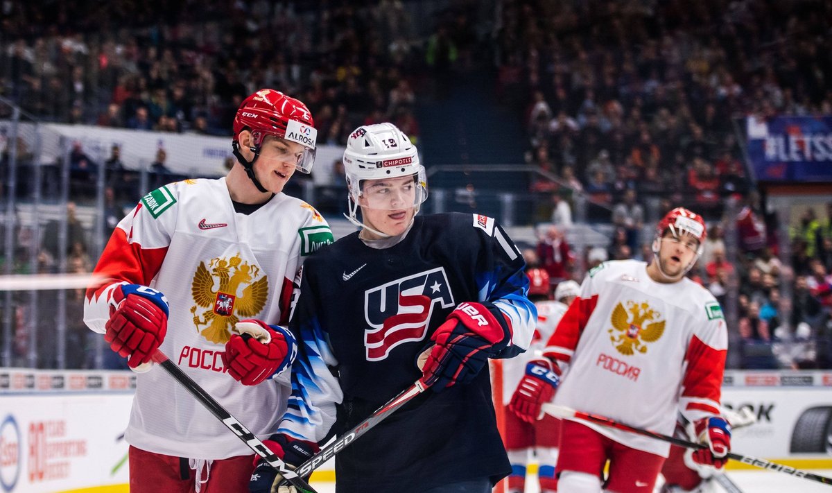 191229 Danil Zhuravlyov of Russia and Cole Caufield of USA during the 2020 IIHF World Junior Championship game between