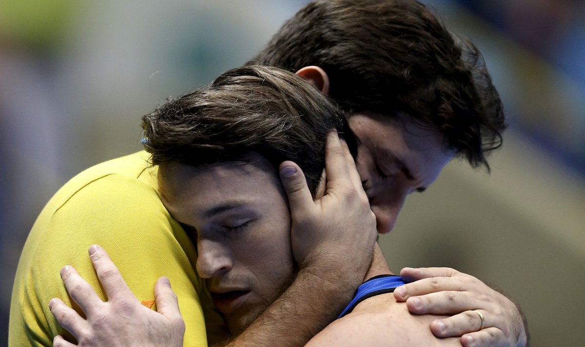 FILE PHOTO: Brazil's Hypolito embraces his coach Lopes after competing in the men's floor exercise qualifying round at the Gymnastics World Challenge Brazil in Sao Paulo