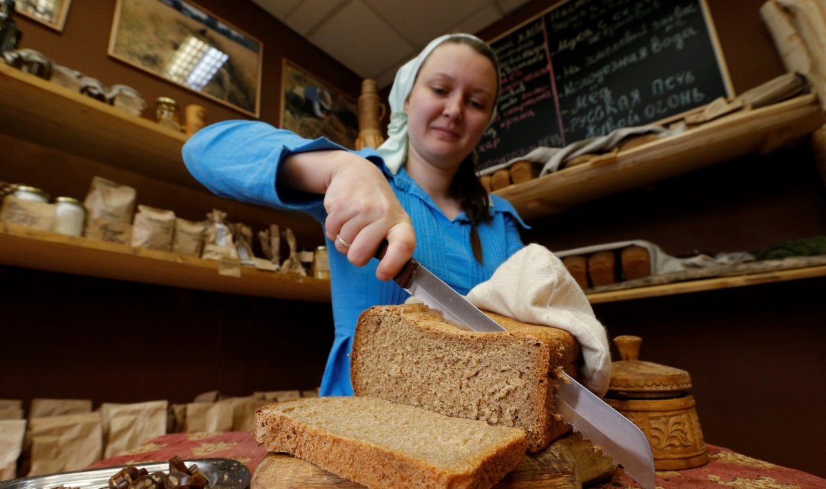 An employee cuts bread at German Sterligov s food store in central Moscow