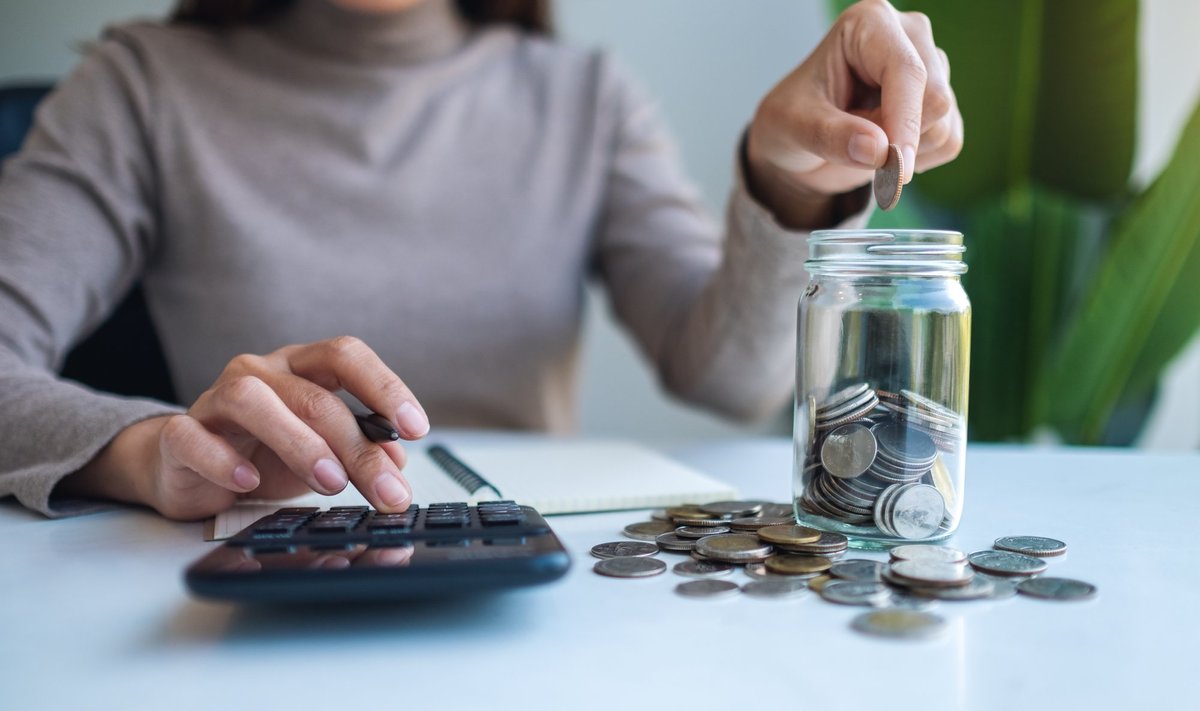 Closeup,Image,Of,A,Woman,Saving,Money,In,A,Glass