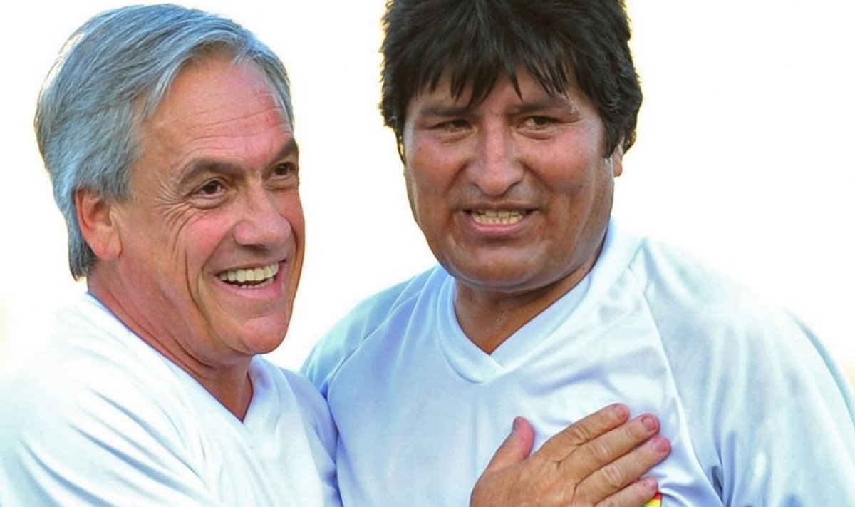 Bolivian President Evo Morales (R) embraces Chile's President-elect Sebastian Pinera during an exhibition football match in Santiago, on March 10, 2010. Pinera will take on the presidency on Thursday in Valparaiso. AFP PHOTO/MARTIN BERNETTI