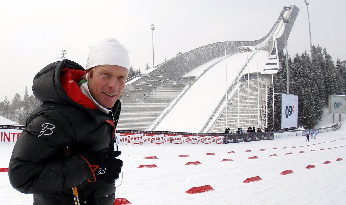 Norway's former cross country skier Daehlie smiles on a cross country track in front of the Holmenkollen ski jump at the at the Nordic Ski World Championships in Oslo