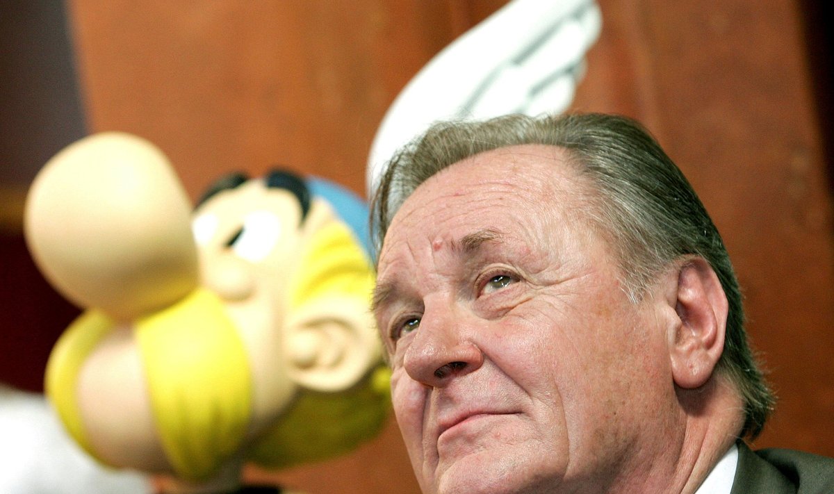 FILE PHOTO: Albert Uderzo, the artist of all thirty-three Asterix adventures and story writer of the last nine books, sits next to a model of Asterix during a news conference in Brussels