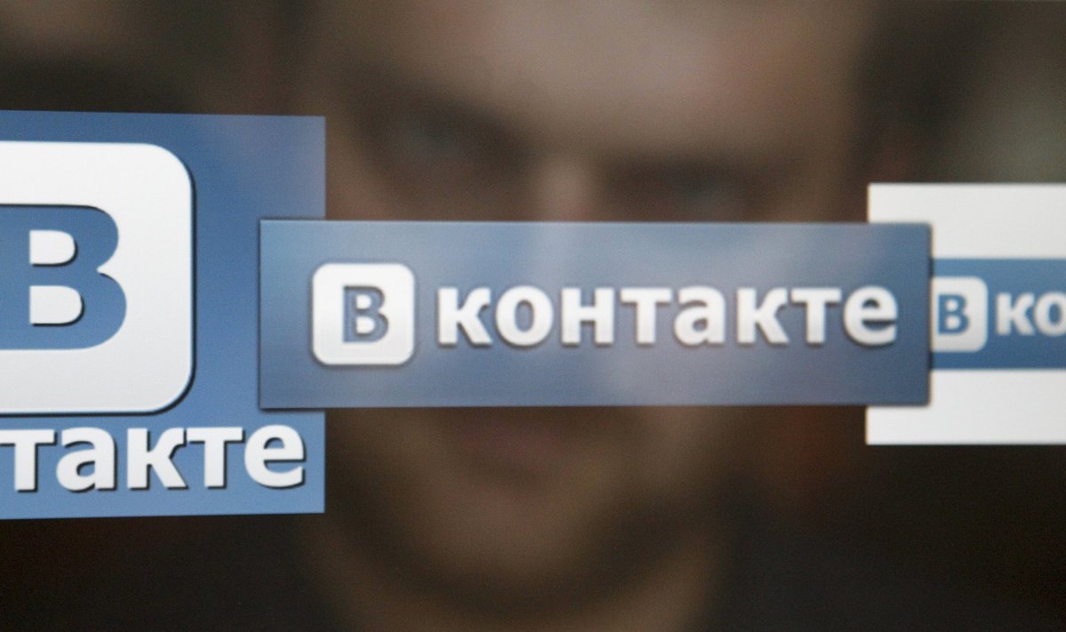 A man looks at a computer screen showing logos of Russian social network VKontakte in Moscow