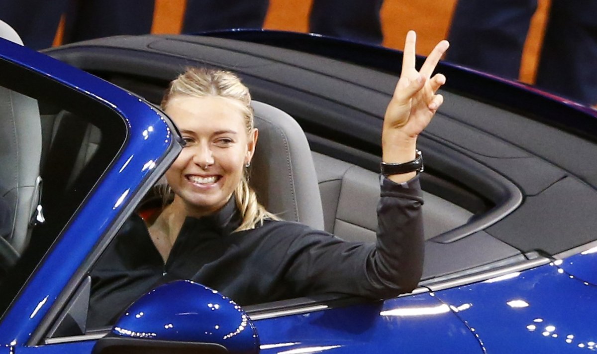 Russia's top seed and holder Sharapova celebrates after she won a Porsche 911 4S in the final of the Stuttgart tennis Grand Prix against China's Li