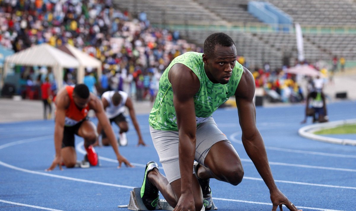Jamaican runner Usain Bolt takes his mark before running in the men's 400m race in Kingston