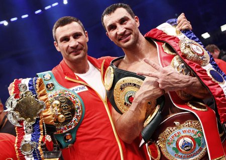 Klitschko of Ukraine celebrates with his brother after defeating Haye of Britain in a heavyweight title unification boxing match in Hamburg