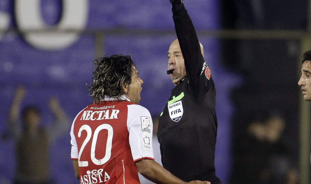 Colombia's Independiente Santa Fe player Bedoya receives red card by referee Lopes during their first semi final match of the Copa Libertadores in Asuncion