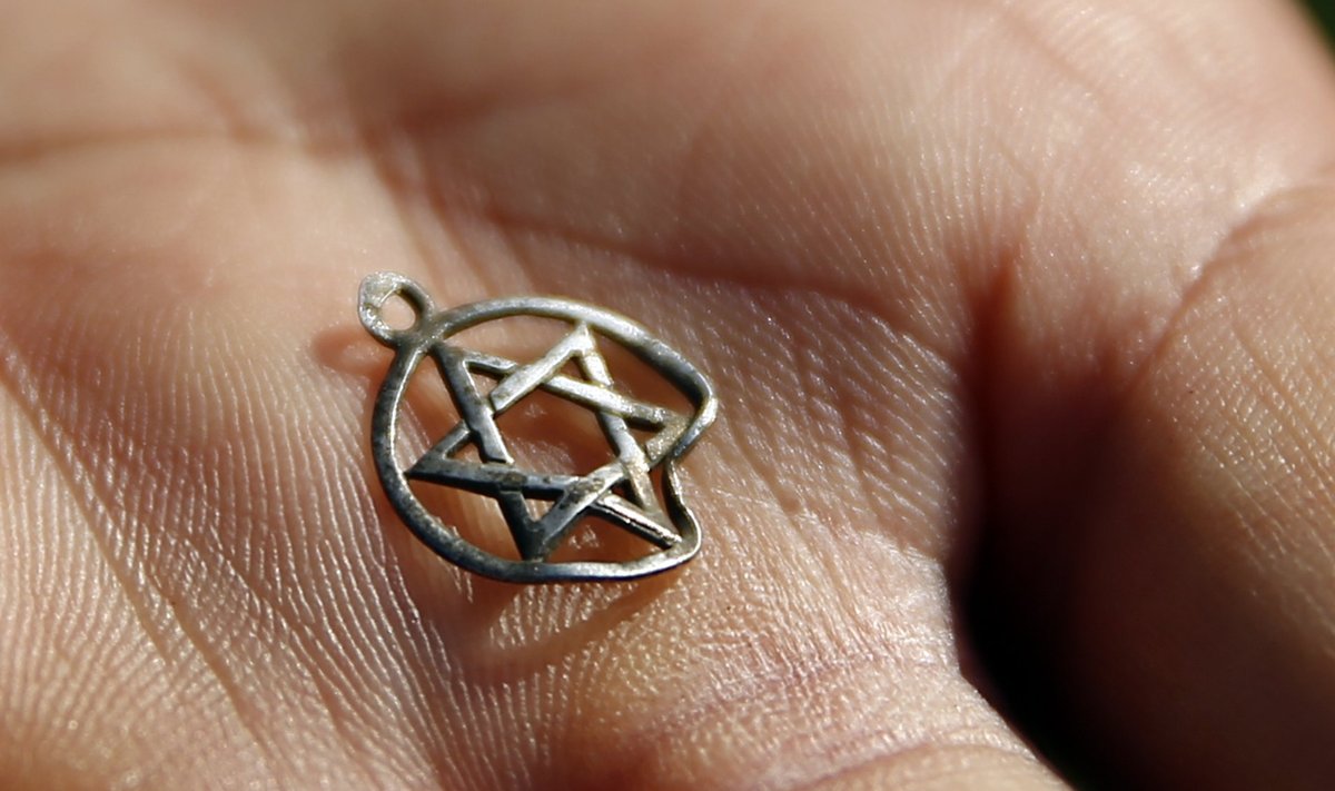 A medallion in the shape of the Star of David is shown after being discovered in the perimeter of a Nazi death camp in Sobibor