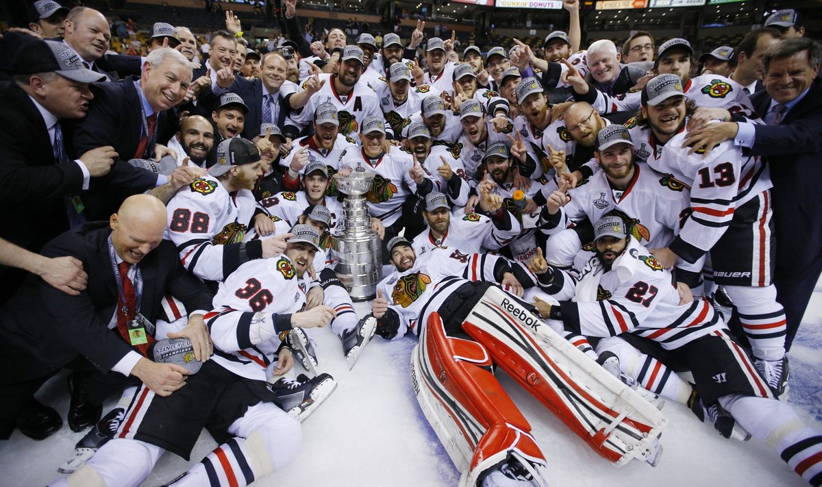 The Chicago Blackhawks players, coaches and staff pose with the Stanley Cup after defeating the Boston Bruins in Game 6 of their NHL Stanley Cup Finals hockey series in Boston