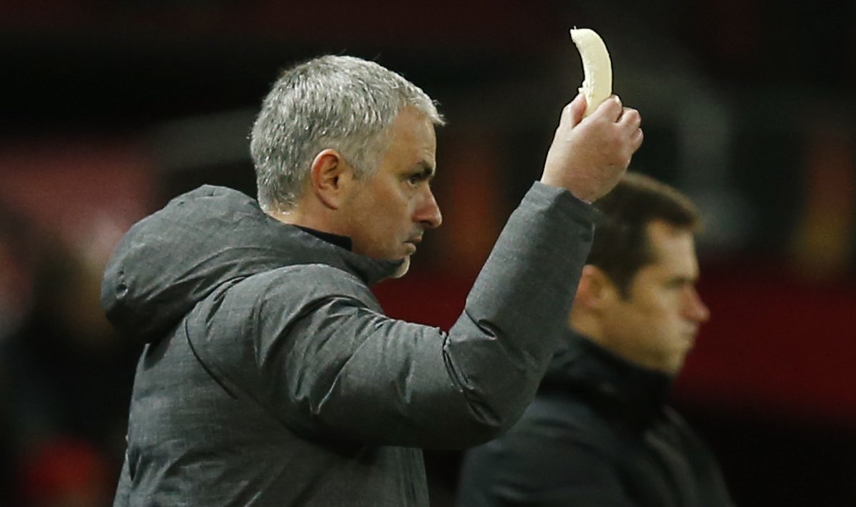 Manchester United manager Jose Mourinho holds a banana which is later passed to Marcos Rojo