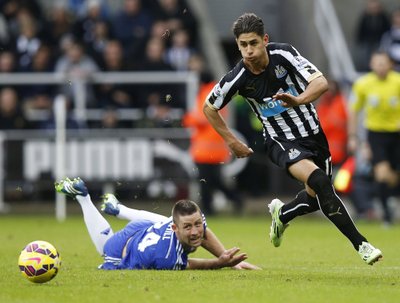 Ayoze Perez of Newcastle United runs past Gary Cahill of Chelsea during their English Premier League soccer match at St James' Park in Newcastle
