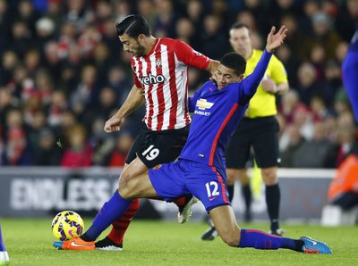 Southampton's Graziano Pelle is challenged by Manchester United's Chris Smalling during their English Premier League soccer match at St Mary's Stadium in Southampton