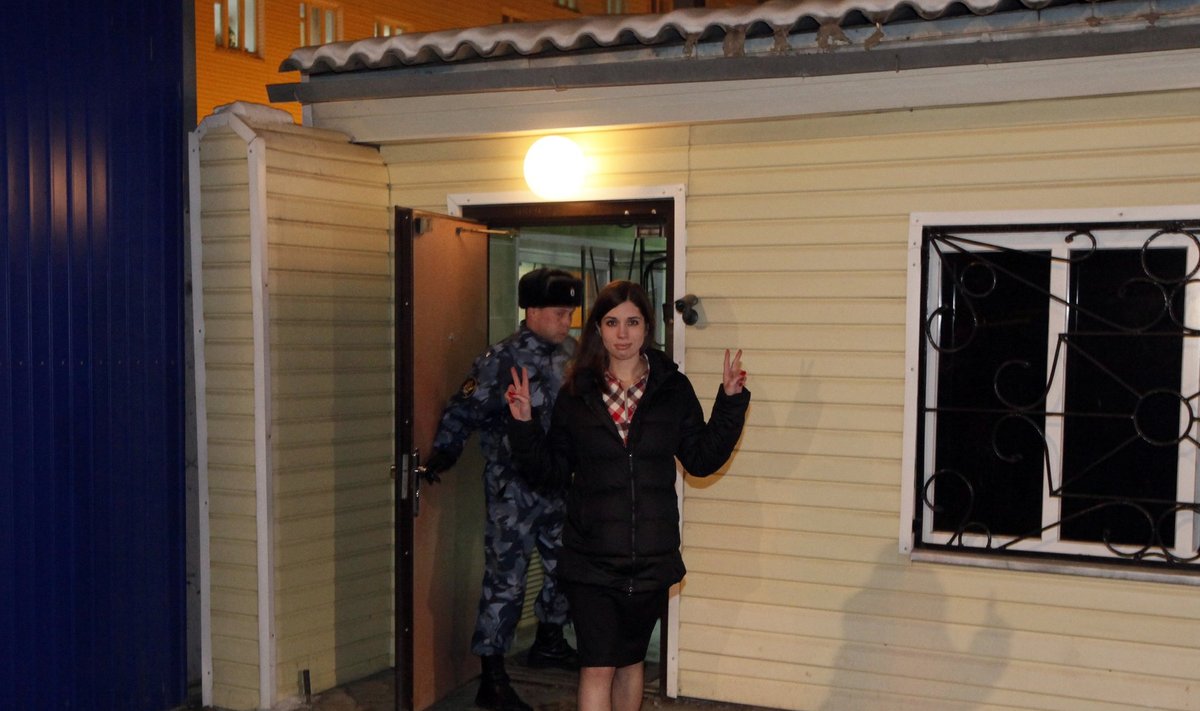 Pussy Riot member Tolokonnikova gestures as she walks out of prison in Krasnoyarsk