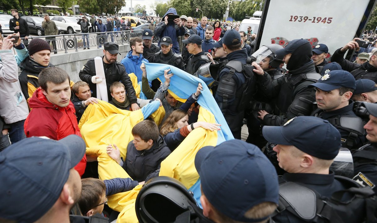 Ukrainian riot police officers block supporters of far-right parties who tried to prevent Immortal Regiment march, during Victory Day celebrations in Kiev