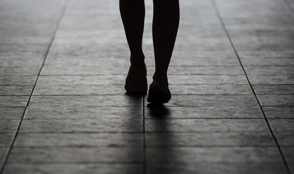 Silhouette,Woman,Walking,On,Street.