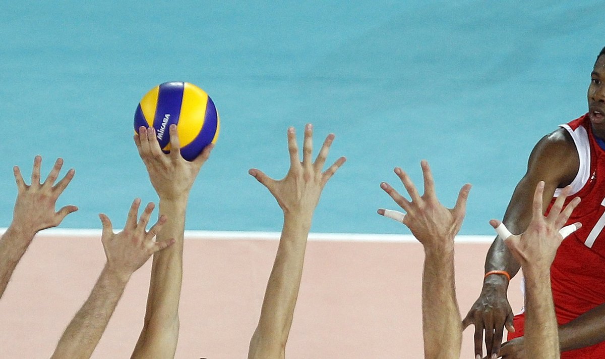 Leon Venero of Cuba spikes the ball against Serbia's players during their FIVB Men's Volleyball World Championship semifinal match in Rome