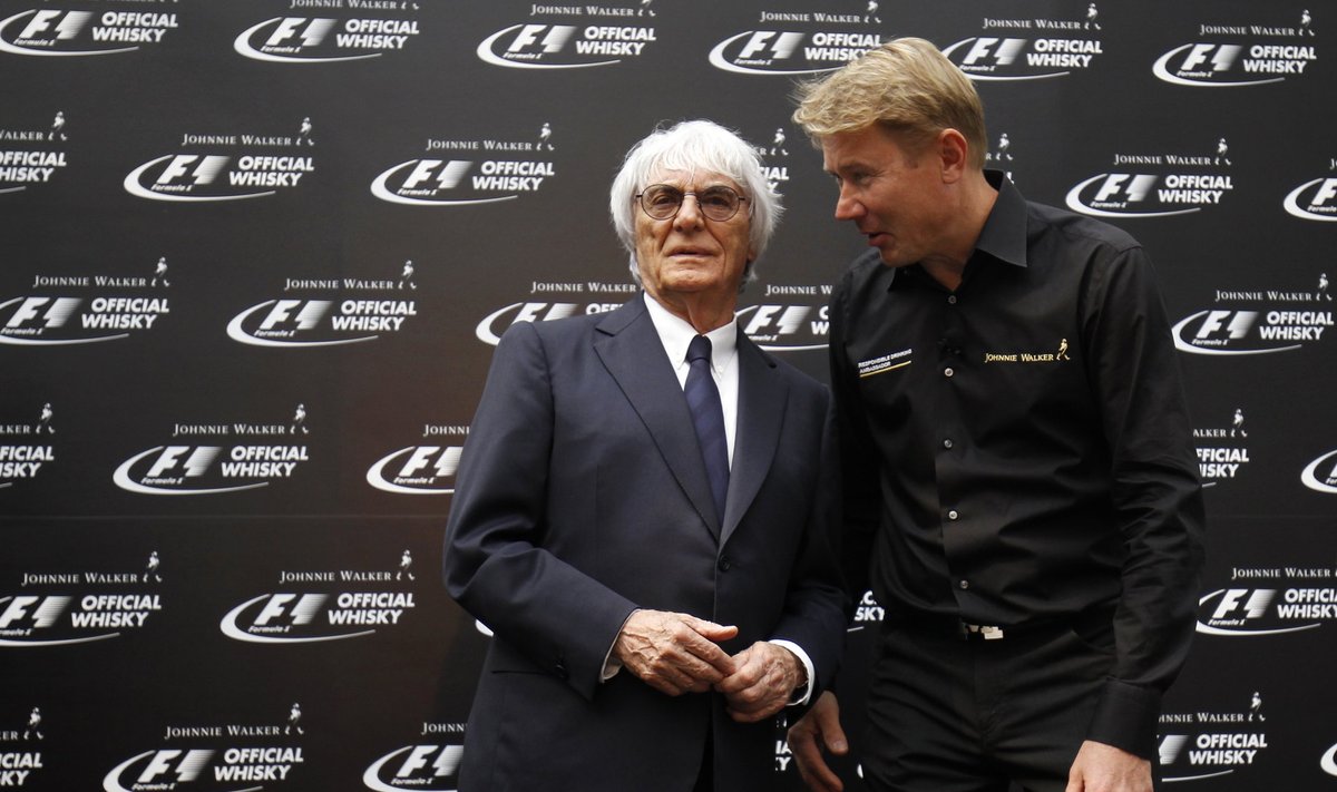 Formula One commercial supremo Ecclestone talks to former Formula One driver Hakkinen of Finland during an event at a hotel ahead of the Singapore F1 Grand Prix at the Marina Bay street circuit in Singapore