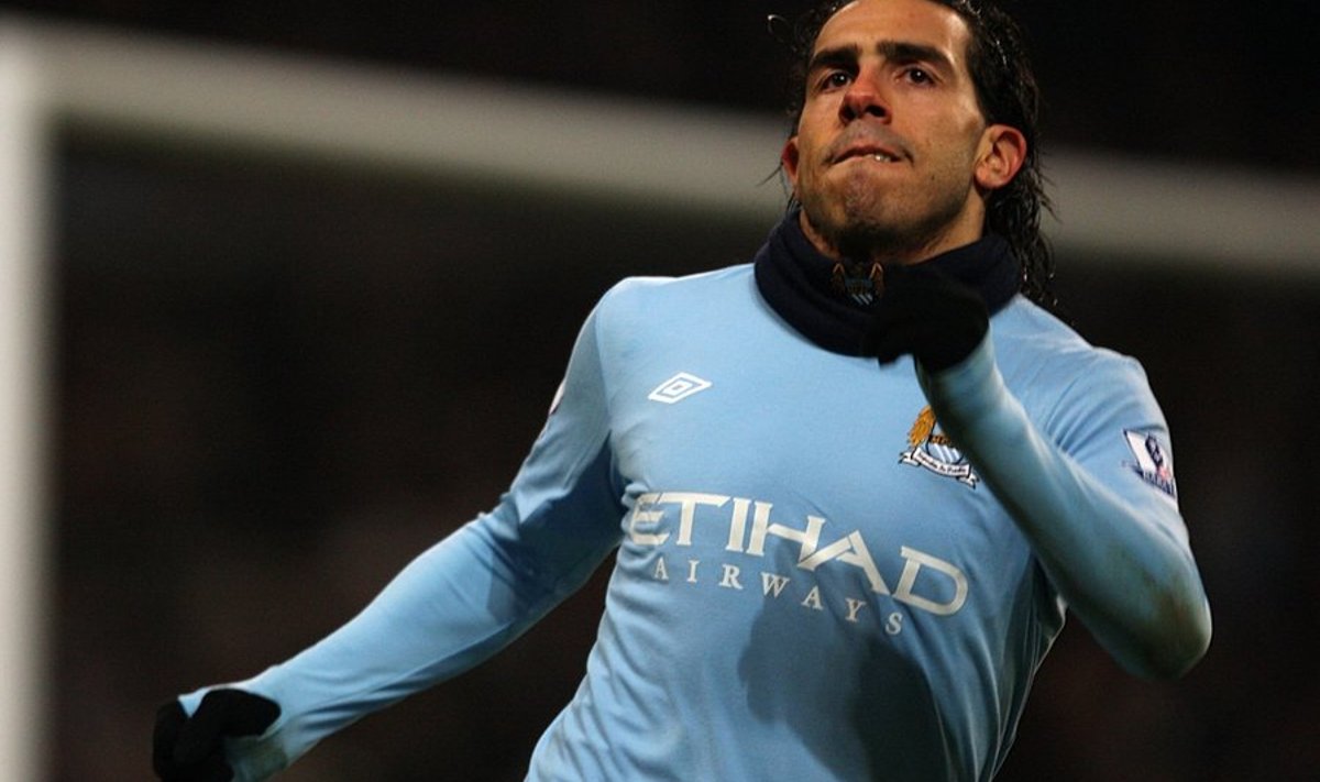 Manchester City's Carlos Tevez celebrates after he scores his second and his sides third goal of the game