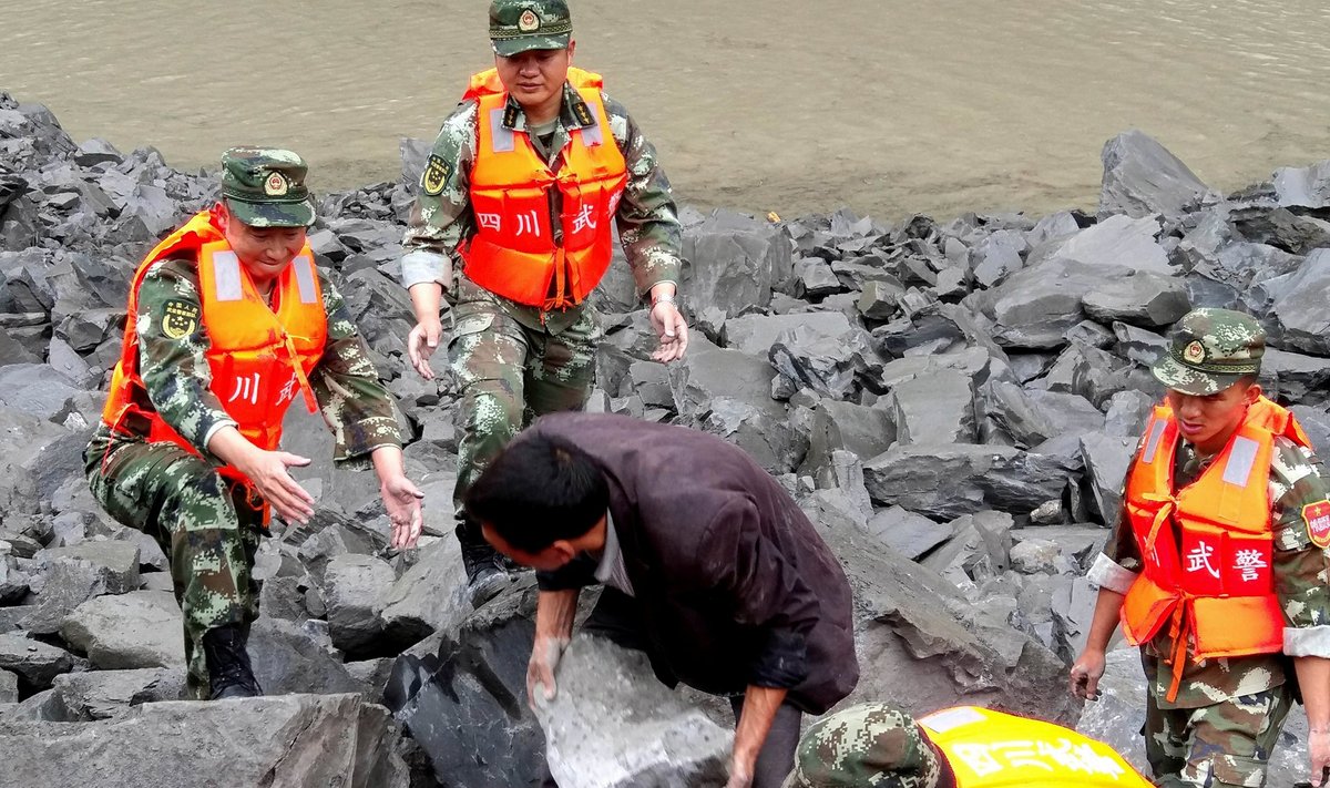 Rescue personnel work at landslide site that occurred in Xinmo Village