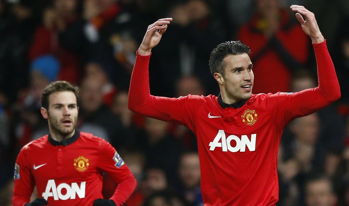 Manchester United's  looks on as teammate Robin van Persie celebrates scoring against Cardiff City during their English Premier League soccer match in Manchester, northern England