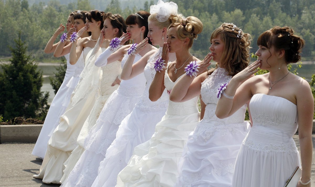 Married women dressed in wedding and fancy dresses participate in the annual Parade of Brides festival in Krasnoyarsk