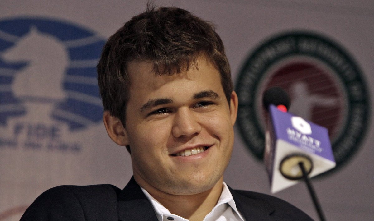 Norway's Carlsen smiles during a joint conference at the FIDE World Chess Championship in Chennai