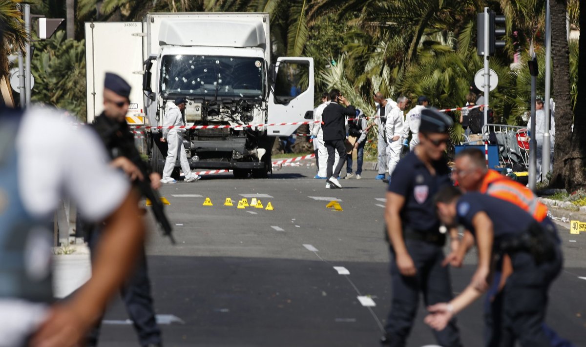French police secure the area as the investigation continues at the scene near the heavy truck that ran into a crowd at high speed killing scores who were celebrating the Bastille Day July 14 national holiday on the Promenade des Anglais in Nice