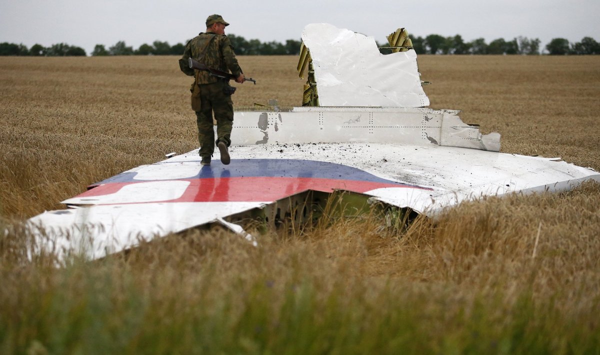 Venemeelne relvastatud separatist seisab hukkunud lennuki detaili peal.