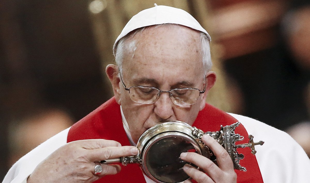 Pope Francis kisses the vial of what local Roman Catholics believe is the blood of Saint Gennaro during a meeting with members of the clergy at the Duomo during his pastoral visit in Naples