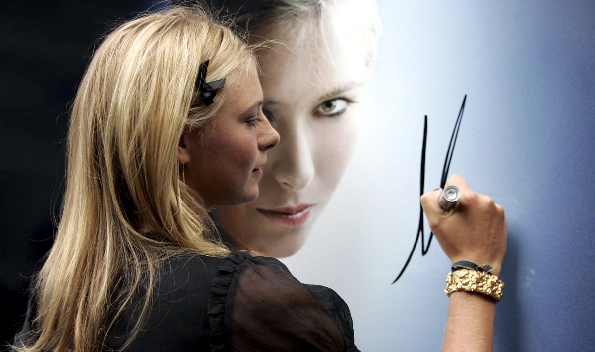 File photo of Maria Sharapova signing a poster in New York