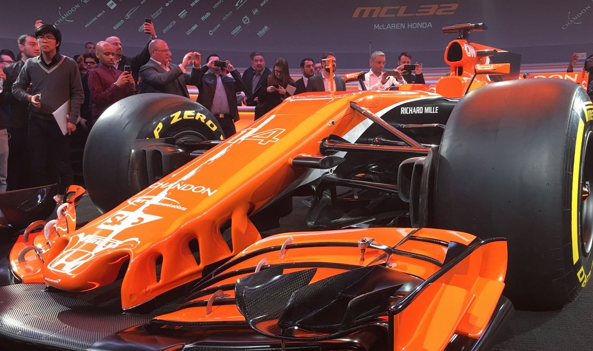 Journalists use their mobile phones to photograph McLaren's new MCL32 Formula One car at its launch in Woking