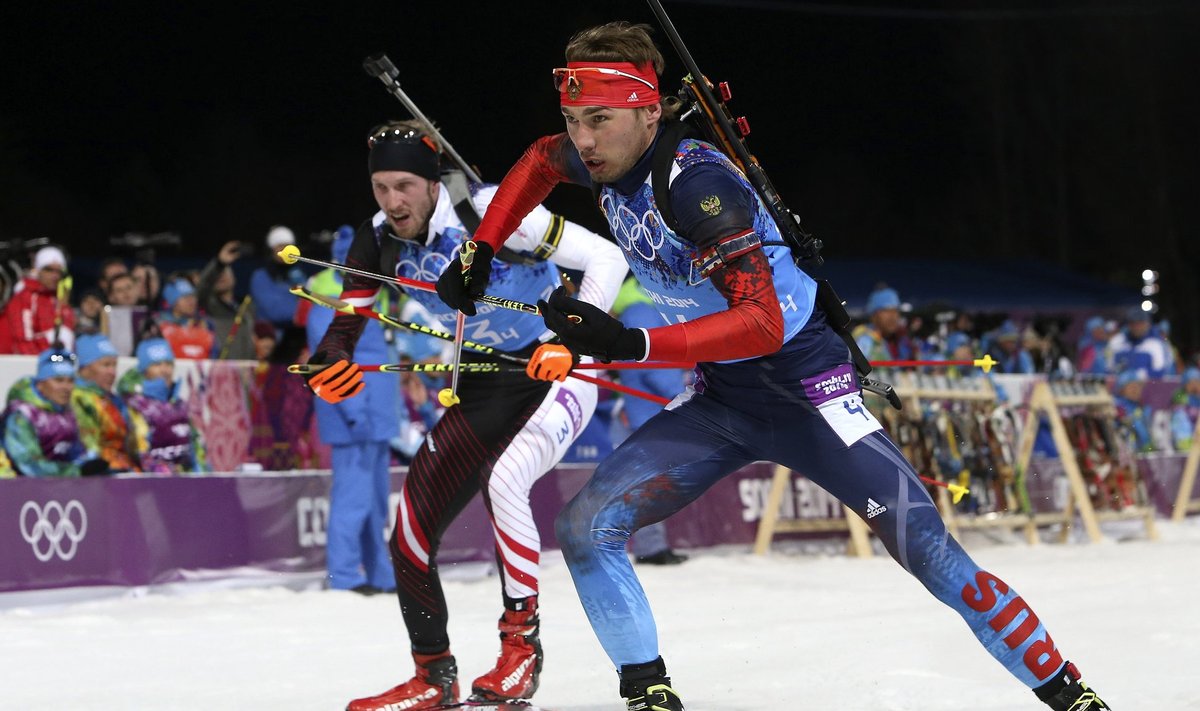 Russia's Shipulin skis next to Germany's Schempp during the men's biathlon 4 x 7.5 km relay at the Sochi 2014 Winter Olympic Games in Rosa Khutor