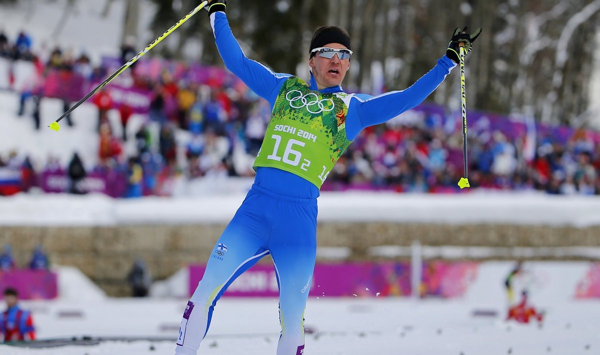 Finland's Jauhojaervi celebrates as he crosses finish line in men's cross-country team sprint classic final at 2014 Sochi Olympic Games