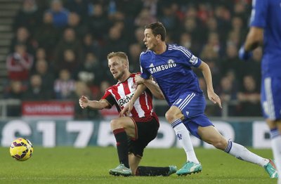 Sunderland's Sebastian Larsson is challenged by Chelsea's Nemanja Matic during their English Premier League soccer match at the Stadium of Light in Sunderland