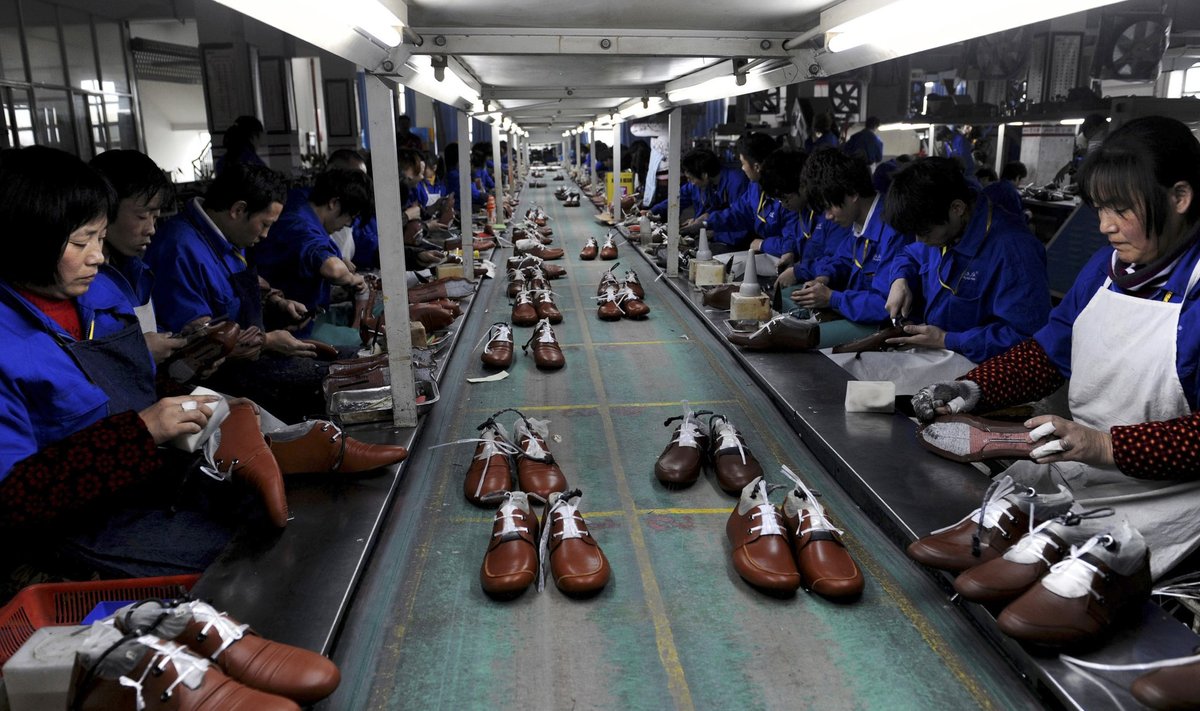 Employees work at a shoe factory in 