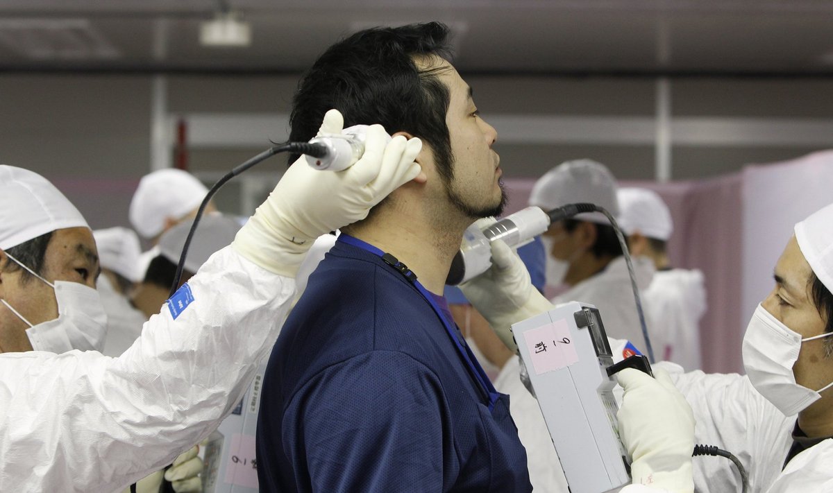 File photo of a worker being screened for radiation as he enters the emergency operation center at TEPCO's tsunami-crippled Fukushima Daiichi nuclear power plant in Fukushima