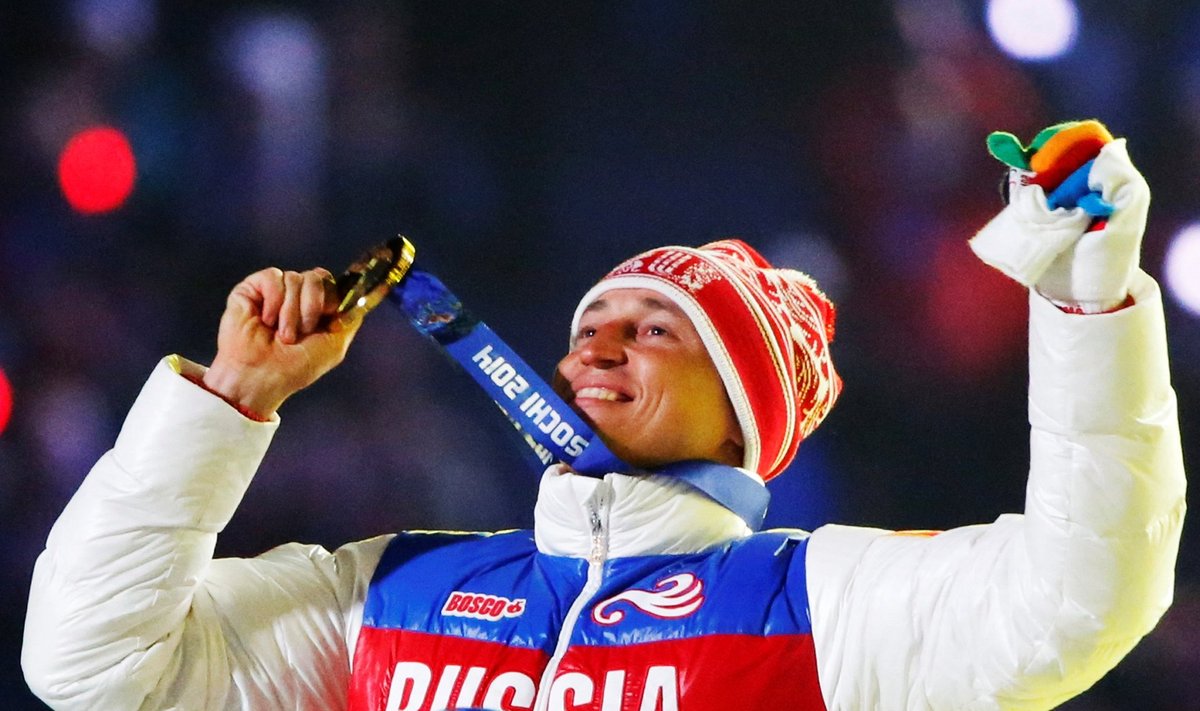 Russian gold medalist Legkov celebrates as he receives his medal during closing ceremony for Sochi 2014 Winter Olympics
