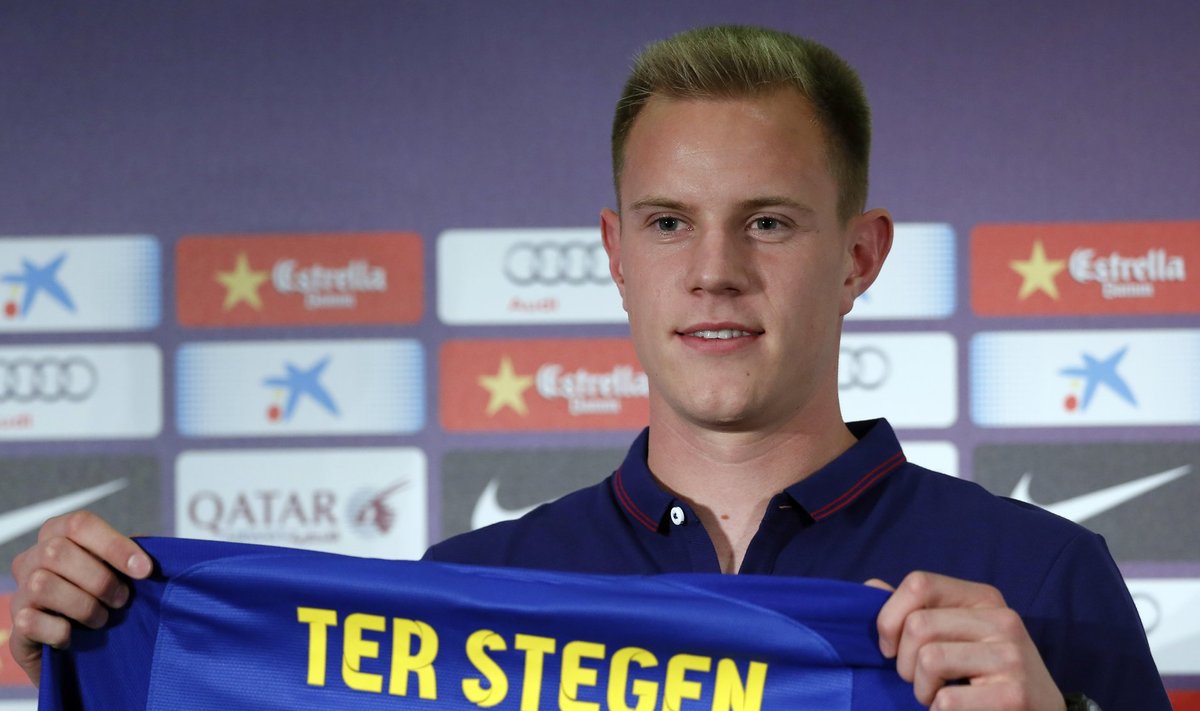 FC Barcelona's new goalkeeper Marc-Andre Ter Stegen poses with his new jersey after signing a five-year contract at the Camp Nou stadium in Barcelona