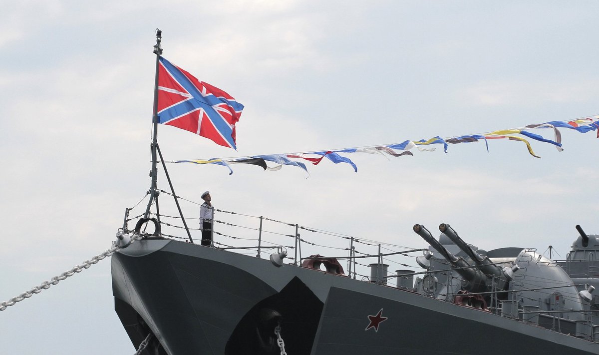 A Russian sailor stands onboard a warship during a naval parade rehearsal in the Crimean port of Sevastopol