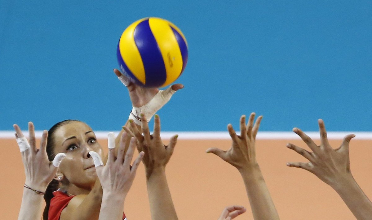 Goncharova of Russia spikes the ball against Li, Zeng, and Yuan of China during their FIVB Women's Volleyball World Grand Prix 2014 final round match in Tokyo