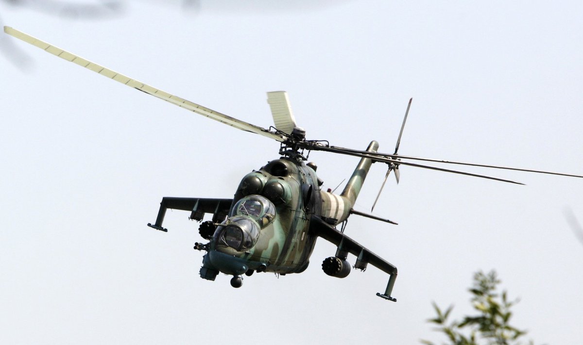 A Ukrainian helicopter Mi-24 gunship flies above a military base in Kramatorsk